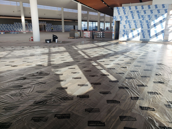 Floor in office construction being protected by carpet cover